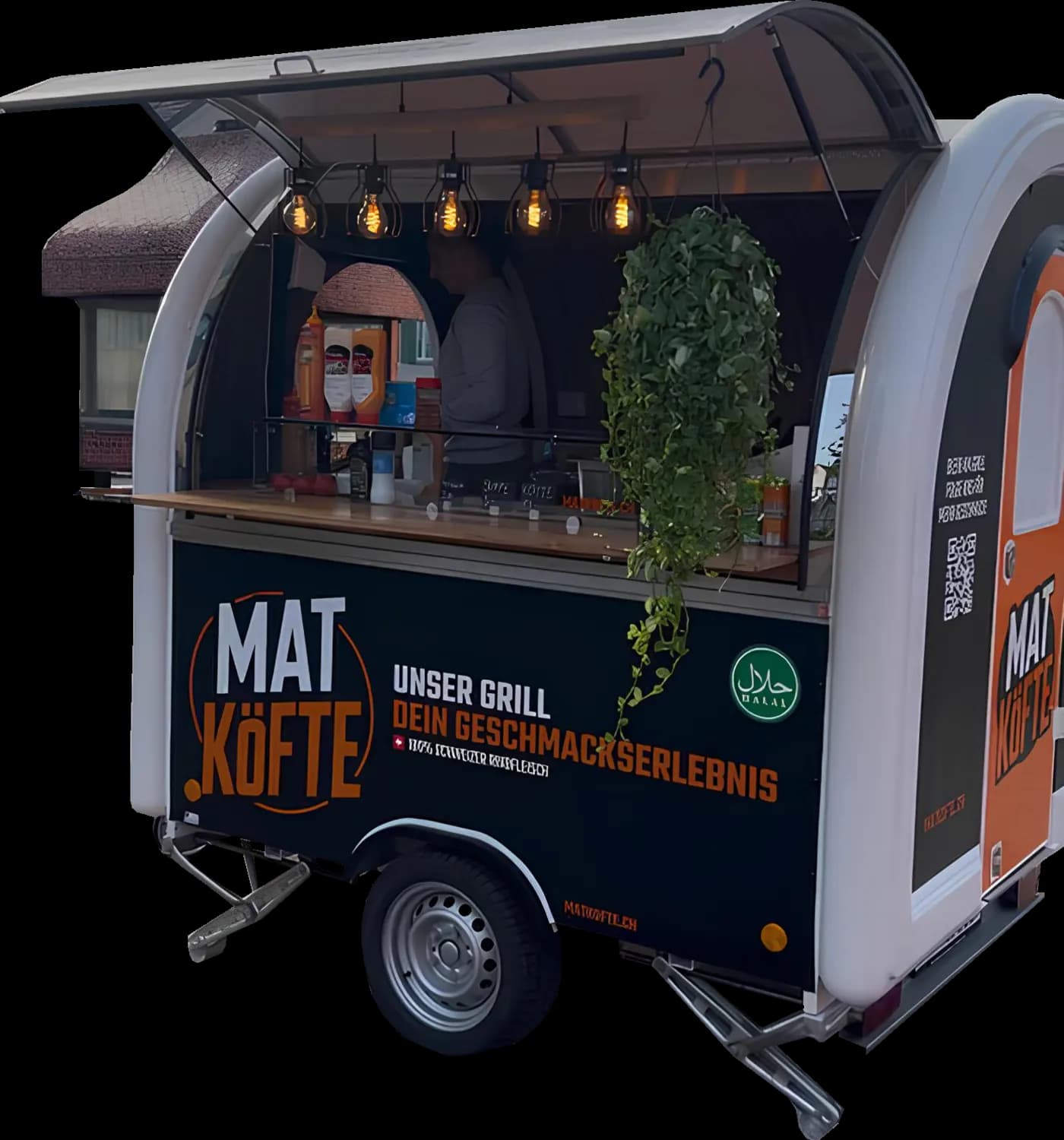 Fertiger MAT Köfte Foodtruck in Schwarz und Orange mit Glühbirnen und Hängepflanze